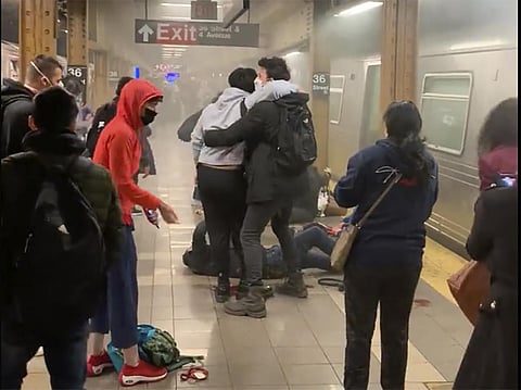 This photo provided by Will B Wylde, a person is aided outside a subway car in the Brooklyn borough of New York, Tuesday, April 12, 2022. (Photo | AP)