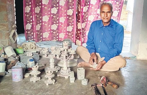 A Gaurahari stonework artisan  with his handicrafts. (Photo | EPS)