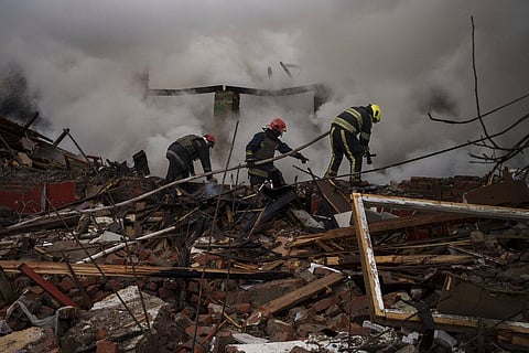 Firefighters work to extinguish a fire after a Russian attack destroyed the building of a Culinary School in Kharkiv, Ukraine (Photo | AP)