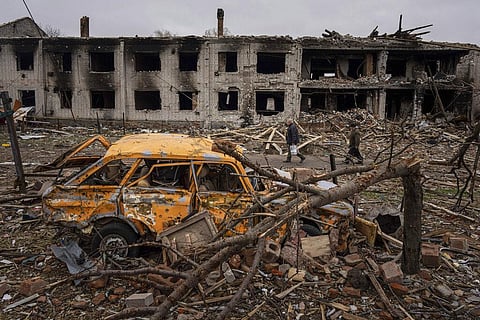 Men walk in a street destroyed by shellings in Chernihiv, Ukraine, Wednesday, April 13, 2022. (Photo | AP)