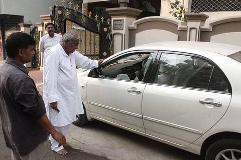 Congress leader V Hanumantha Rao examining the damage in his car after the alleged goon attack. (Photo | Express)