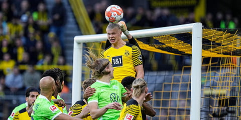 Dortmund's Erling Haaland defends the ball in front of his own goalkeeper Gregor Kobel during a Bundesliga match against VfL Wolfsburg in Dortmund, Germany. (Photo| AP)