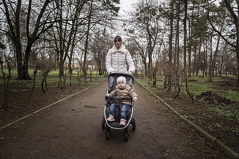 Viktoria Kovalenko and her daughter Varya walk in a park in Lviv, Ukraine, Sunday, April 10, 2022.  (Photo | AP)