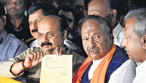 Chief Minister Basavaraj Bommai and former RDPR Minister K S Eshwarappa pose with the latter’s resignation before the media at CM’s residence on Race Course Raod in Bengaluru on Friday night