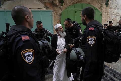 Israel police argues with a Palestinian worshipers the Old City of Jerusalem. (Photo | AP)