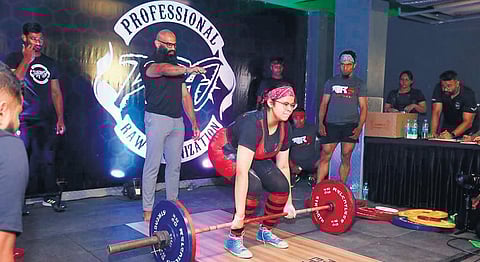 Maryam Mohammed lifting weight during the tournament