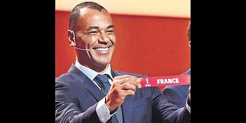 Former Brazilian footballer and World Cup winner Cafu holds the card showing the name of France during the draw for the 2022 World Cup in Qatar on Friday.(Photo | AFP)
