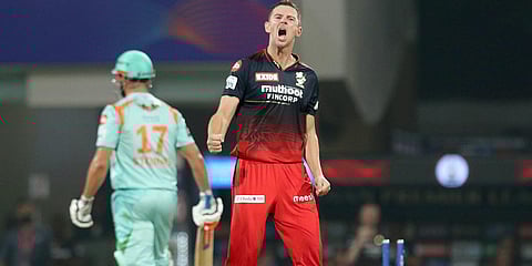 Royal Challengers Bangalore's Josh Hazlewood celebrates the wicket of Lucknow Super Giants' Marcus Stoinis of during an IPL 2022 match at the DY Patil Stadium in Navi Mumbai. (Photo| PTI)