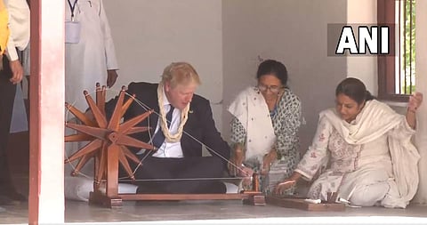 Prime Minister of the United Kingdom Boris Johnson visits Sabarmati Ashram, tries his hands on 'charkha'. (Photo | ANI screengrab)