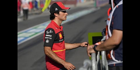Ferrari driver Carlos Sainz of Spain walks across pit lane to watch the Australian Formula One Grand Prix after he withdrew in Melbourne, Australia, Sunday, April 10, 2022. (Photo | AP)