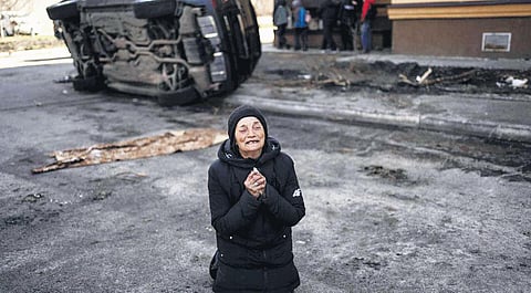 An elderly woman wailing in Bucha