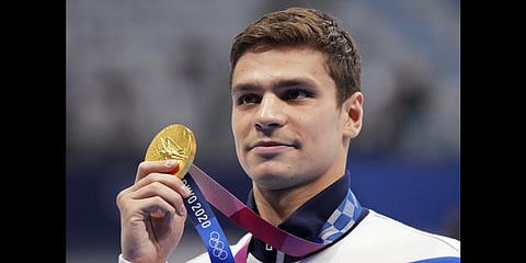 Evgeny Rylov of the Russian Olympic Committee poses with his gold medal for the men's 100-meter backstroke final at the 2020 Summer Olympics, Tuesday, July 27, 2021, in Tokyo, Japan.(Photo | AP)
