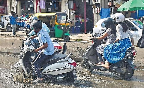 Last week’s rain has once again exposed the city’s crumbling road infrastructure. Here, motorists struggle to manoeuvre a pothole-ridden, water-logged road |shriram bn