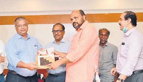 Former chief secretary Paul Antonyhanding over the report on PSUs to Industries Minister P Rajeeve