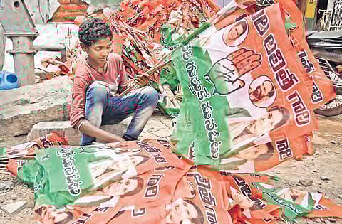 A boy sorts Congress party flags in Hyderabad. (File Photo| Vinay Madapu)