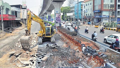 An earth mover clears way for the expansion of Rasoolpura nala in Hyderabad on Friday