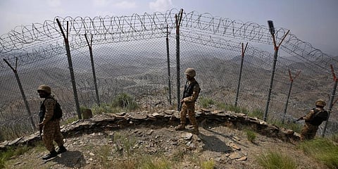 Pakistan Army troops patrol along the fence on the Pakistan Afghanistan border. Representational image. (File Photo | AP)