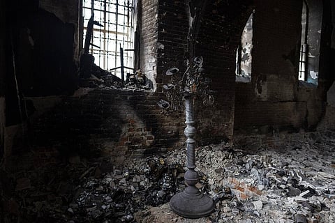 A stand for candles stands inside a damaged church in Lukashivka, northern Ukraine, on Friday, April 22, 2022.(Photo | AP)