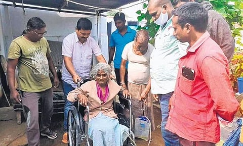 IAS officer Parikipandla Narahari (2nd from left) and Alaya Foundation volunteers handover a wheelchair to a differently-abled elderly person | Express