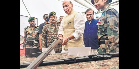 Defence Minister Rajnath Singh checks a weapon at an exhibition during a function honouring the heroes of 1971 Bangladesh Liberation War, in Guwahati on Saturday.(PTI Photo)