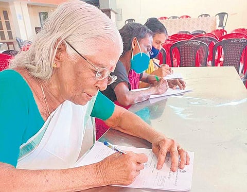 83-year-old P Malathi taking the literacy test conducted by the Kerala State  Literacy Mission.