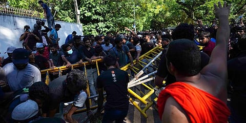 Sri Lankan university students push down police barricades during a protest over the country’s worst economic crisis in decades outside the residence of PM Mahinda Rajapaksa in Colombo. (Photo | AP)