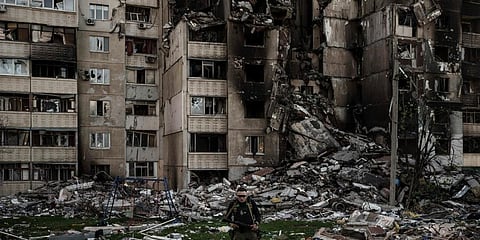 A Ukrainian serviceman walks amid the rubble of a building heavily damaged by multiple Russian bombardments near a frontline in Kharkiv. (Photo | AP)