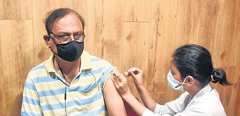 A health worker administers Covid-19 vaccine to a beneficiary | parveen negi