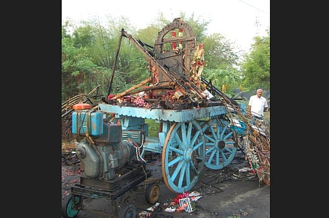 The car procession completed going through the village and while manoeuvring the car to its stand the top of the decorated car touched the overheaprocession completed going through the village