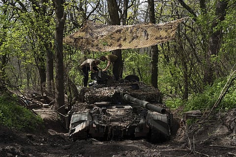 Ukrainian servicemen install a machine gun on the tank during the repair works after fighting against Russian forces in Donetsk region, eastern Ukraine. (Photo | AP)