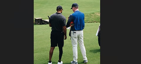 Southern Hills Director of Golf Cary Cozby shares some friendly tips with Tiger Woods. ( Photo | Twitter/@PGA)