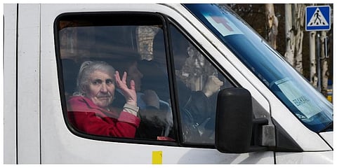 An elderly woman waves from a bus as civillians are evacuated, in Kramatorsk, Ukraine. (File Photo | AP)