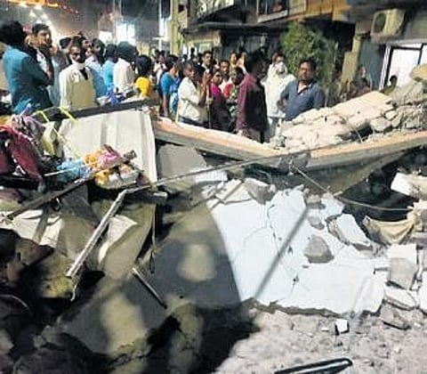 Onlookers gawk at the debris of the parapet wall that collapsed and claimed four lives in Yadadri on Friday. (Photo | EPS)