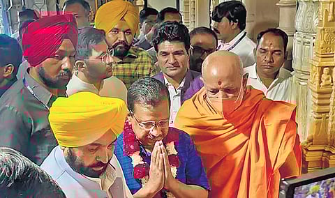 AAP leaders Arvind Kejriwal and Bhagwant Mann offer prayers at the Swaminarayan temple in Ahmedabad on Sunday | pti
