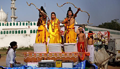 Artists dressed as Lord Rama (R) his brother Lakshman and Sita participate in a religious procession on Ram Navami. (Photo | AP)