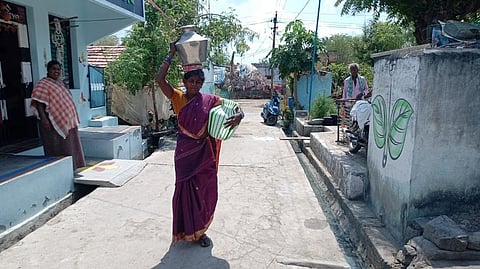A woman carries water at Mangalam village in Perambalur district. ( Photo | EPS)