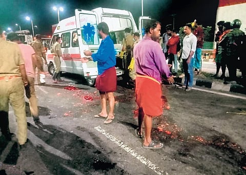 The bodies of the youths being removed from the national highway on Thursday.
