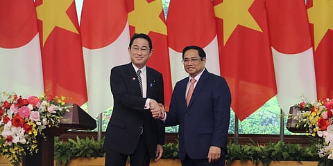 Japanese Prime Minister Fumio Kishida, left, and Vietnamese Prime Minister Pham Minh Chinh shake hands in Hanoi, Vietnam Sunday, May 1, 2022. (Photo | AP)