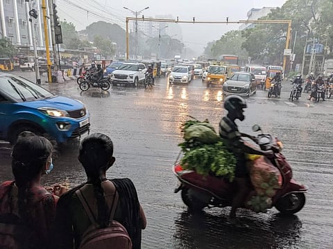 Commuters caught in rain at Thirumangalam In Chennai on Tuesday. (Photo | Debadatta Mallick/EPS)