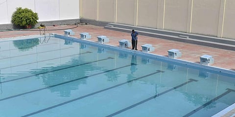 A worker cleans a GHMC swimming pool in Amberpet. (Photo | Vinay Madapu, EPS)