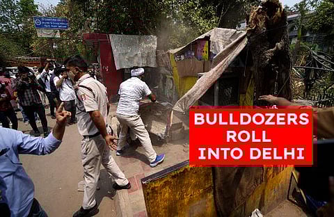 Delhi Municipal Corporation workers dismantled illegal roadside shops during an anti-encroachment drive in New Delhi. (Photo | AP)