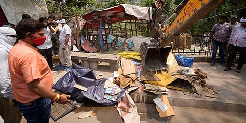 Delhi Municipal Corporation workers dismantle an illegal roadside shop during an anti-encroachment drive in New Delhi. (Photo | AP)