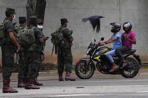 Sri Lankan army soldiers man a checkpoint during curfew imposed a day after clashes between government supporters and anti government protesters in Colombo. (Photo | AP)