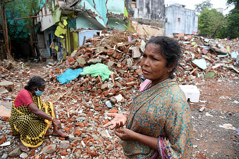 Two elderly women helplessly stare at the debris of a demolished house at Govindasamy Nagar on Greenways Road in Chennai. (Photo | R Satish Babu, EPS)