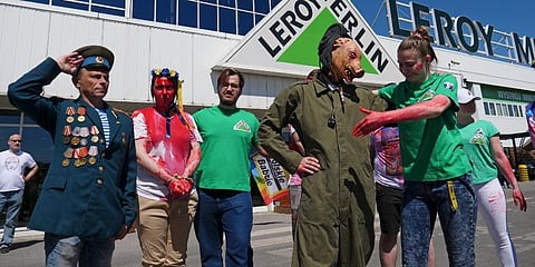 Activists, including Arkadiusz Szczurek, left, take part in a protest outside an outlet of French home improvement retailer Leroy Merlin in Warsaw, Poland. (Photo | AP)