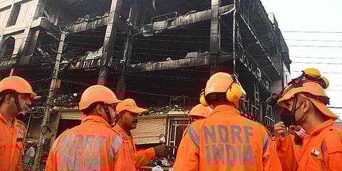 NDRF personnel during rescue and relief work after a massive fire at an office building near the Mundka Metro Station, in New Delhi. (Photo | PTI)