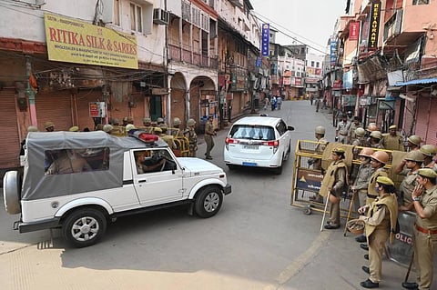 Security personnel stand guard as officials move towards Gyanvapi Masjid complex, to resume a videographic survey, in Varanasi. (Photo | PTI)