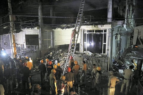 Fire Brigade personnel carry out rescue work after a massive fire which broke out at an office building near the Mundka Metro Station, in West Delhi. (Photo | PTI)
