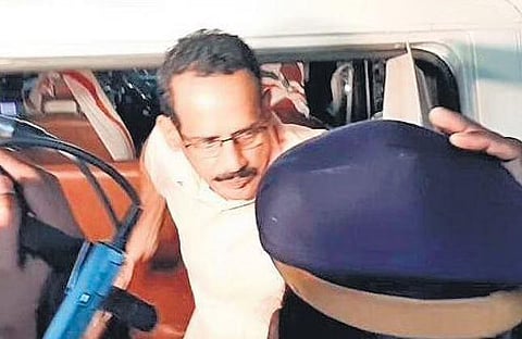 Sasi Kumar K V being taken to the Malappuram police station on Friday