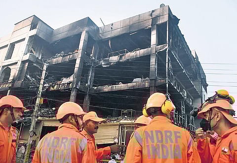 NDRF personnel during rescue work at the gutted building near Mundka Metro Station.  (Photo | PTI)